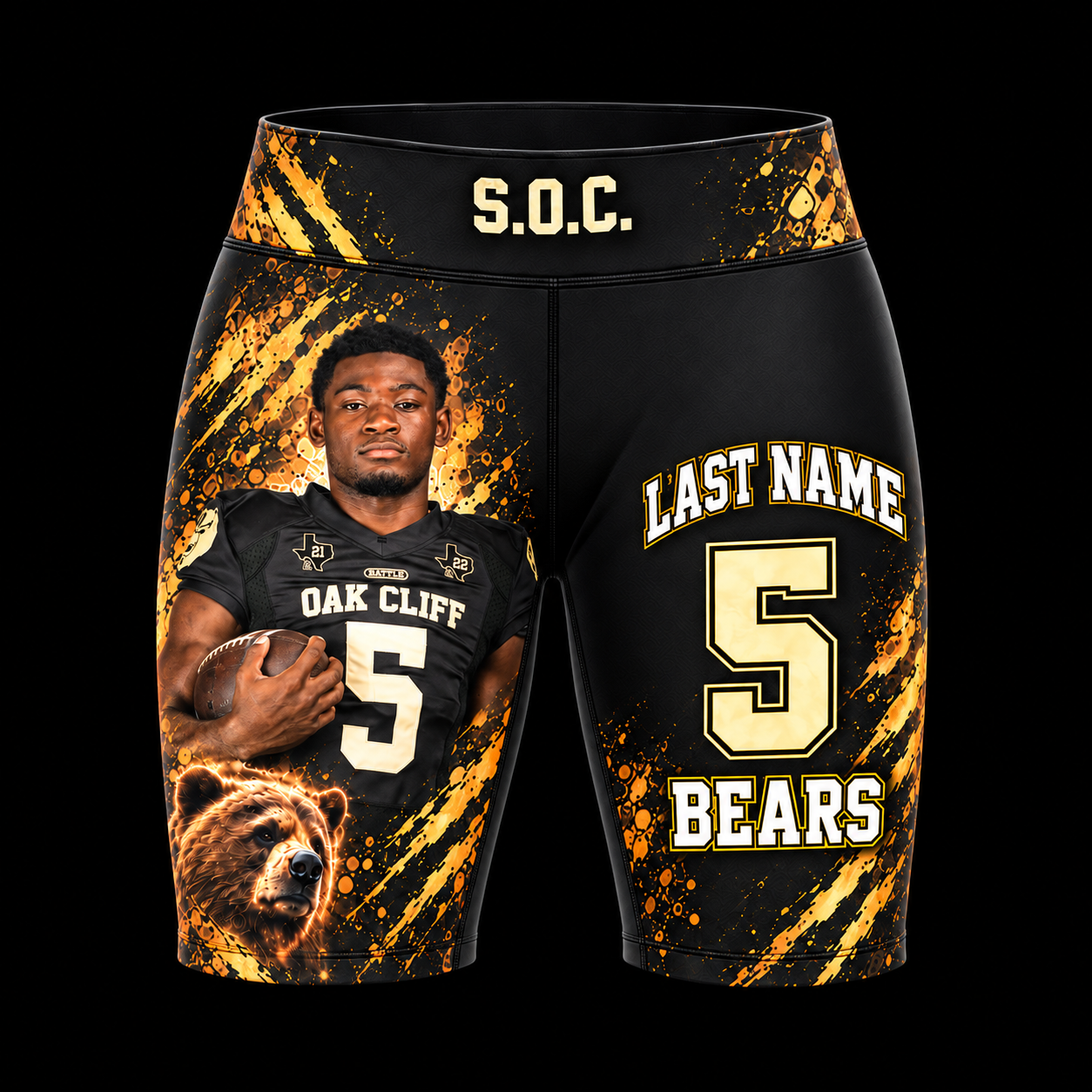 Front of custom fitted shorts tights with a black-and-gold South Oak Cliff athlete photo design on a black background