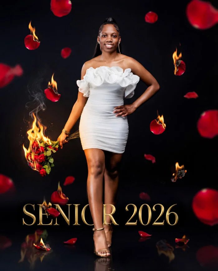 SUBVISION senior portrait in a white dress with red rose petals, flames and gold Senior 2026 lettering